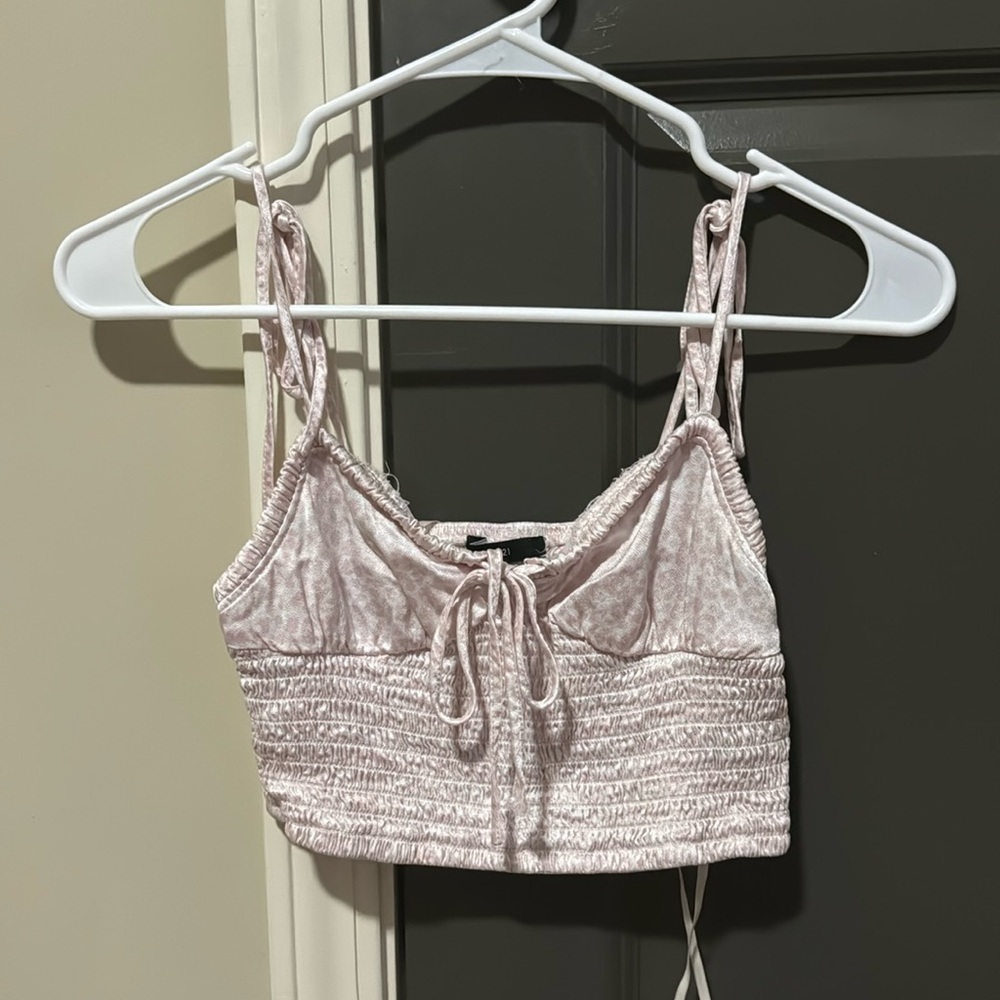 Pink cheetah print crop tank top. Straps are tie. Price is negotiable